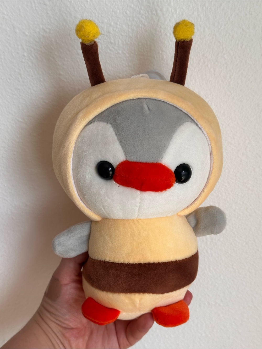 Suction penguin with bee outfit